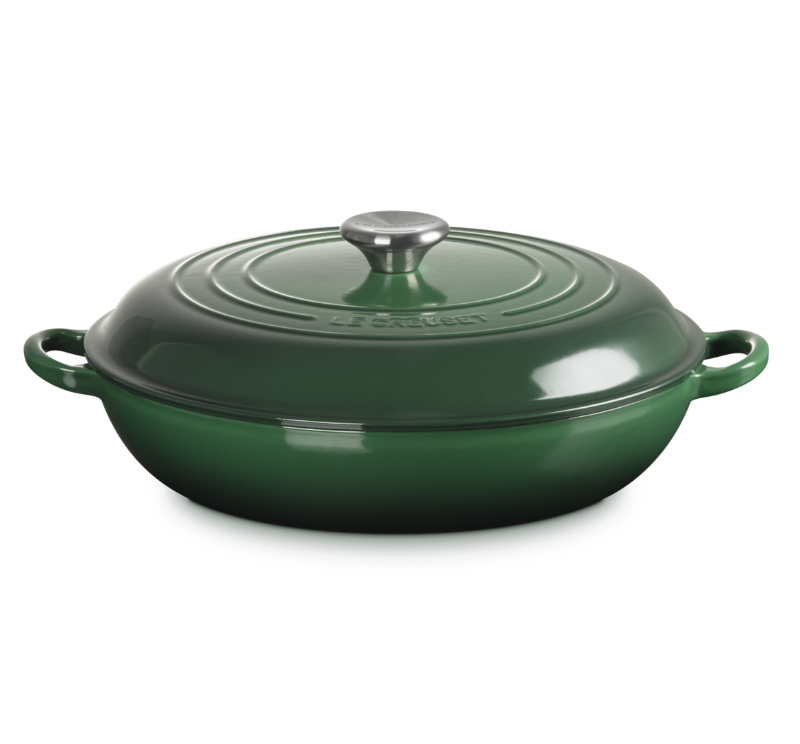 Green cast iron cookware with lid on a white background