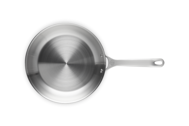 Stainless steel frying pan on a white background