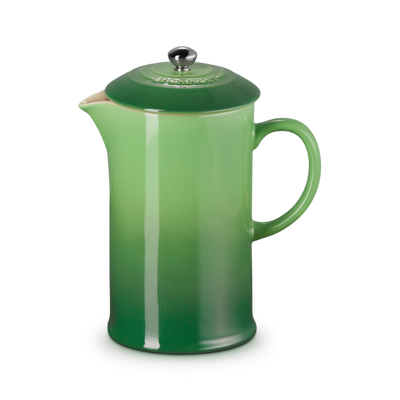 Green French press coffee maker on a white background