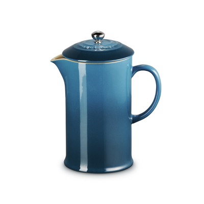 Blue French press coffee maker on a white background