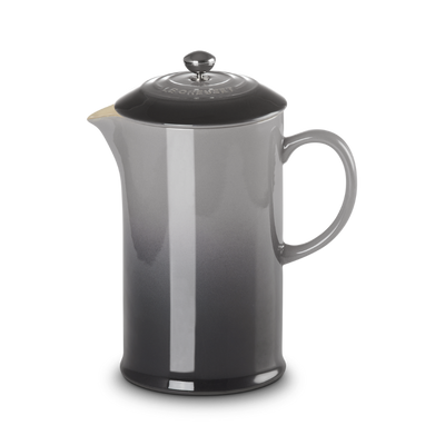 Black French press coffee maker on a white background