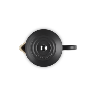 Black teapot with a lid on a white background