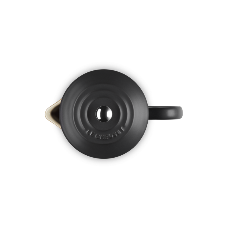 Black teapot with a lid on a white background