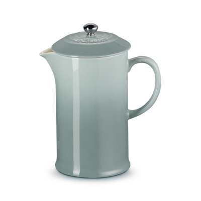 Gray ceramic pitcher with a lid on a white background