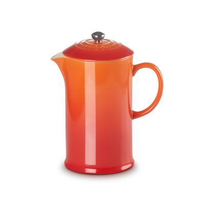Orange ceramic pitcher on a white background