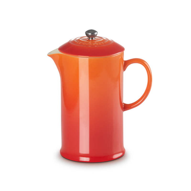Orange ceramic pitcher on a white background