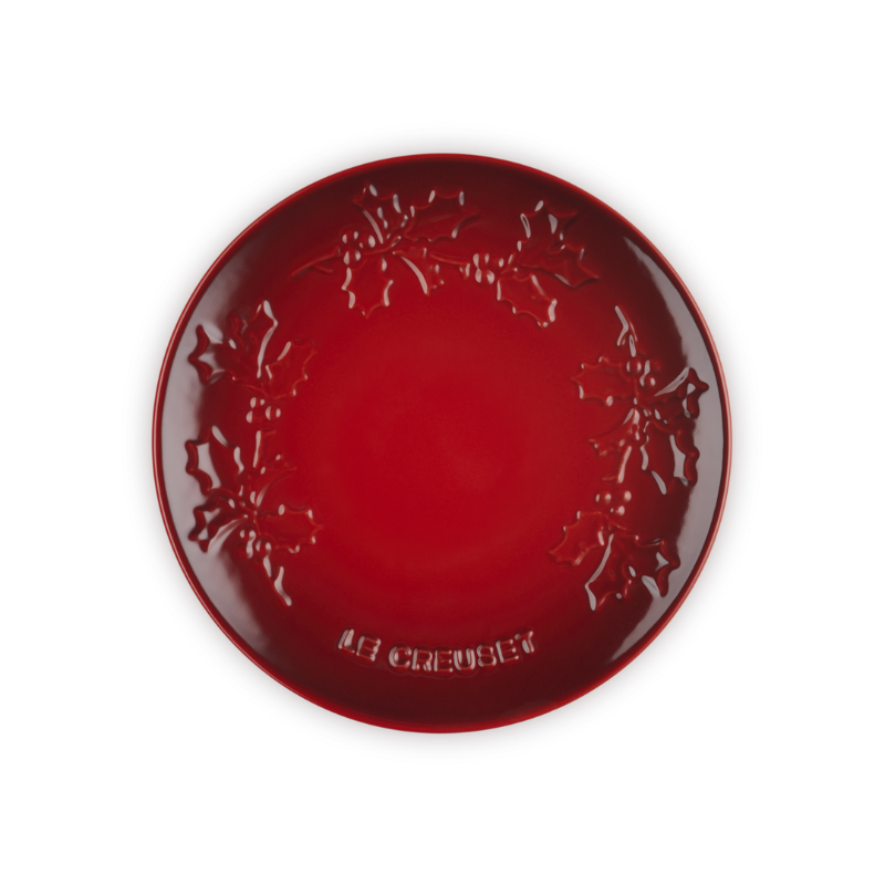 Red decorative plate with intricate patterns on a white background