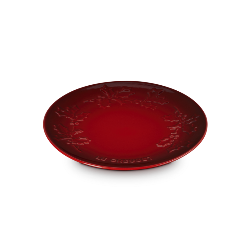 Red ceramic plate with intricate design on a white background