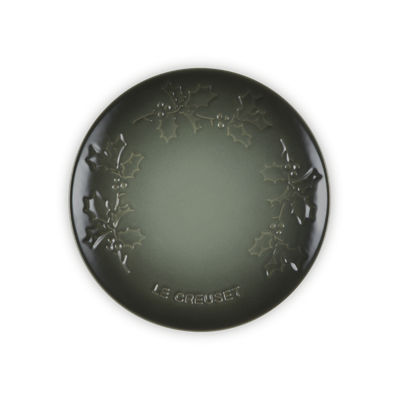 Round black decorative item with floral patterns on a white background