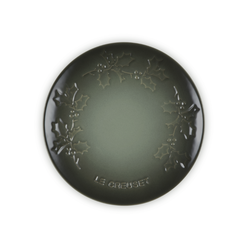 Round black decorative item with floral patterns on a white background