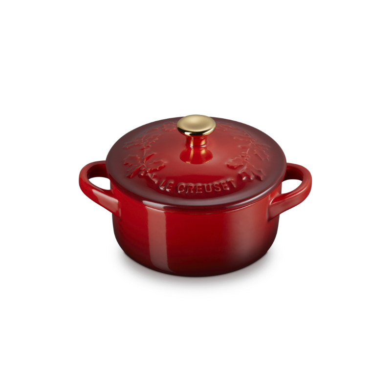 Red enameled cast iron cookware pot with lid on a white background