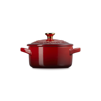 Red ceramic pot with lid on a white background