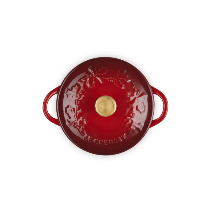 Red enameled cast iron casserole dish on a white background