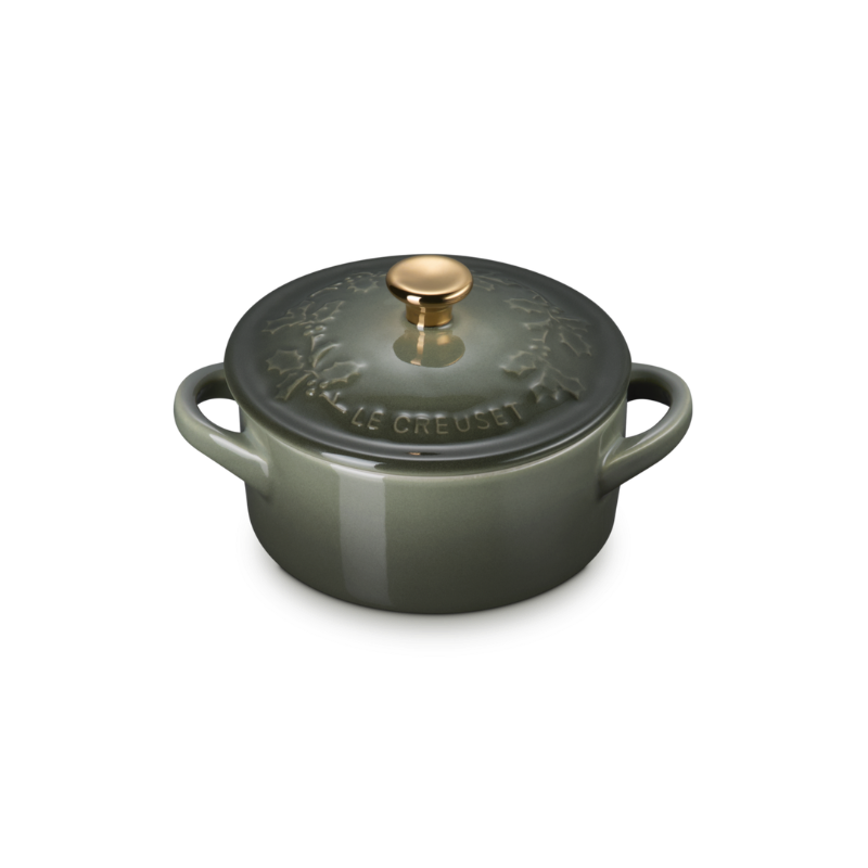 Green cast iron cookware pot with lid on a white background