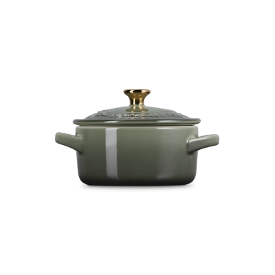 Green cookware pot with lid on a white background