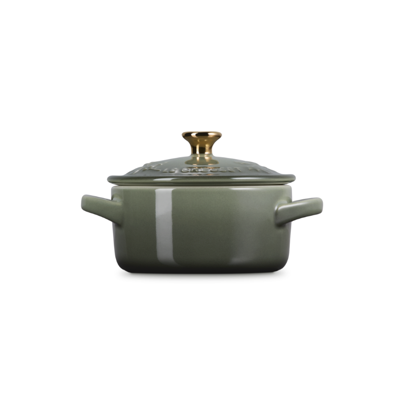 Green cookware pot with lid on a white background