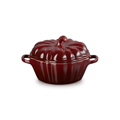Red ceramic pot with a lid on a white background