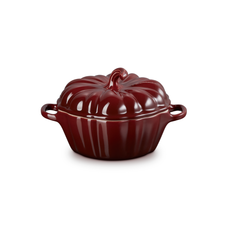 Red ceramic pot with a lid on a white background