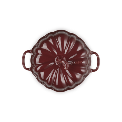 Red ceramic dish with handles on a white background