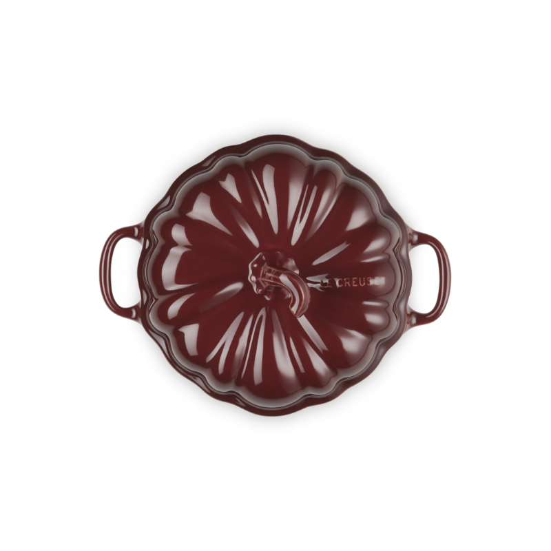 Red ceramic dish with handles on a white background