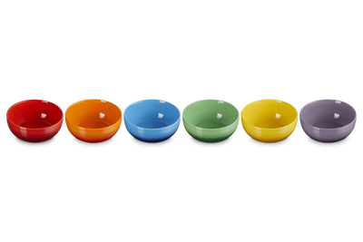 Set of six colorful bowls in a row on a white background