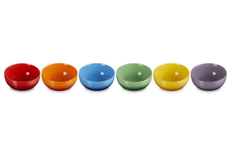 Set of six colorful bowls in a row on a white background