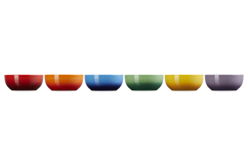 Set of six colorful bowls arranged in a row on a white background