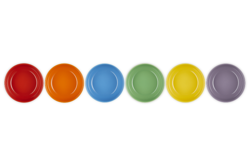 Set of six colorful plates in red, orange, blue, green, yellow, and purple on a white background.