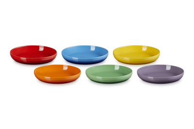 Set of six colorful ceramic plates on a white background