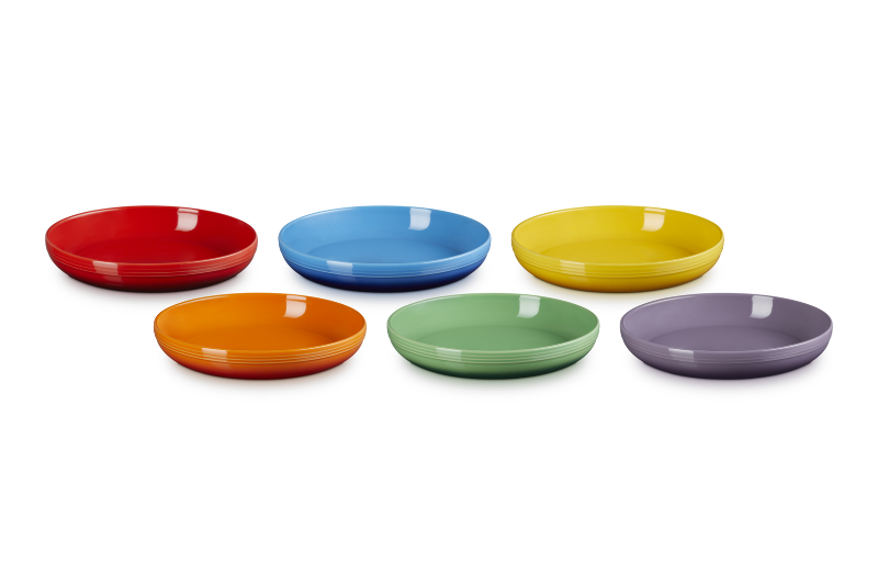 Set of six colorful ceramic plates on a white background