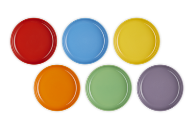 Set of six colorful round plates on a white background