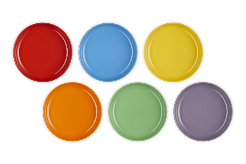 Set of six colorful round plates on a white background