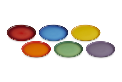 Set of six colorful plates in red, blue, yellow, orange, green, and purple on a white background.