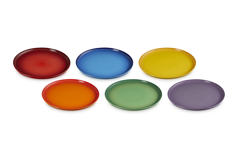 Set of six colorful plates in red, blue, yellow, orange, green, and purple on a white background.