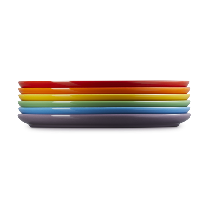 Stack of colorful plates on a white background