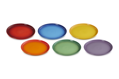 Set of six colorful ceramic plates on a white background