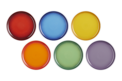 Set of six colorful round plates on a white background