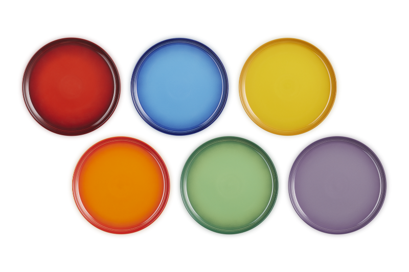 Set of six colorful round plates on a white background