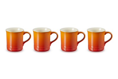 Four orange mugs with white interiors on a white background