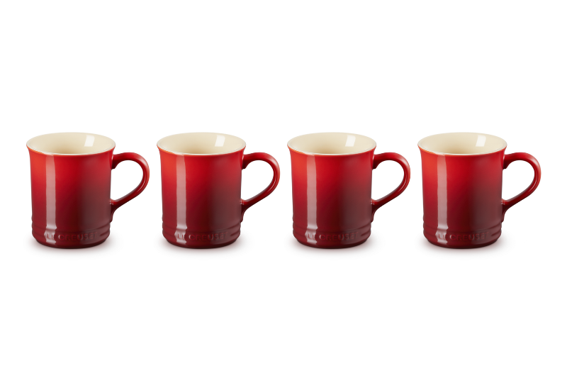 Four red mugs with beige interior on a white background