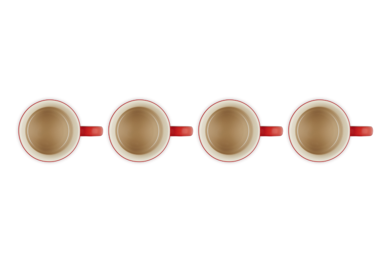 Four red-rimmed ceramic mugs on a white background