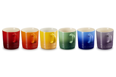 Set of six colorful mugs with different designs on a white background