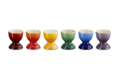 Set of six colorful egg cups on a white background