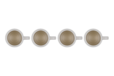 Four white mugs with brown interior on a white background