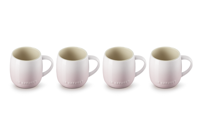 Four ceramic mugs with a subtle pattern on a white background