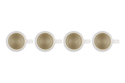 Four white coffee cups with gold interior on a white background