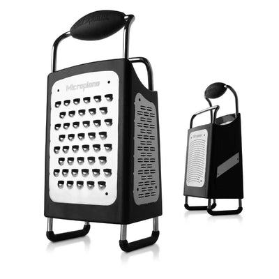 Black box grater with multiple sides on a white background