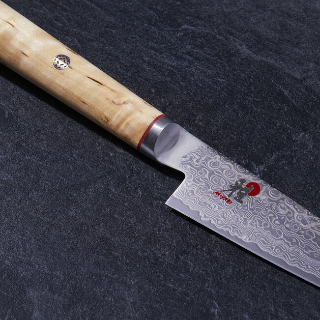 Japanese knife with a wooden handle on a dark surface