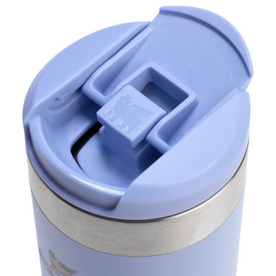 Close-up of a light blue travel mug with a lid on a white background