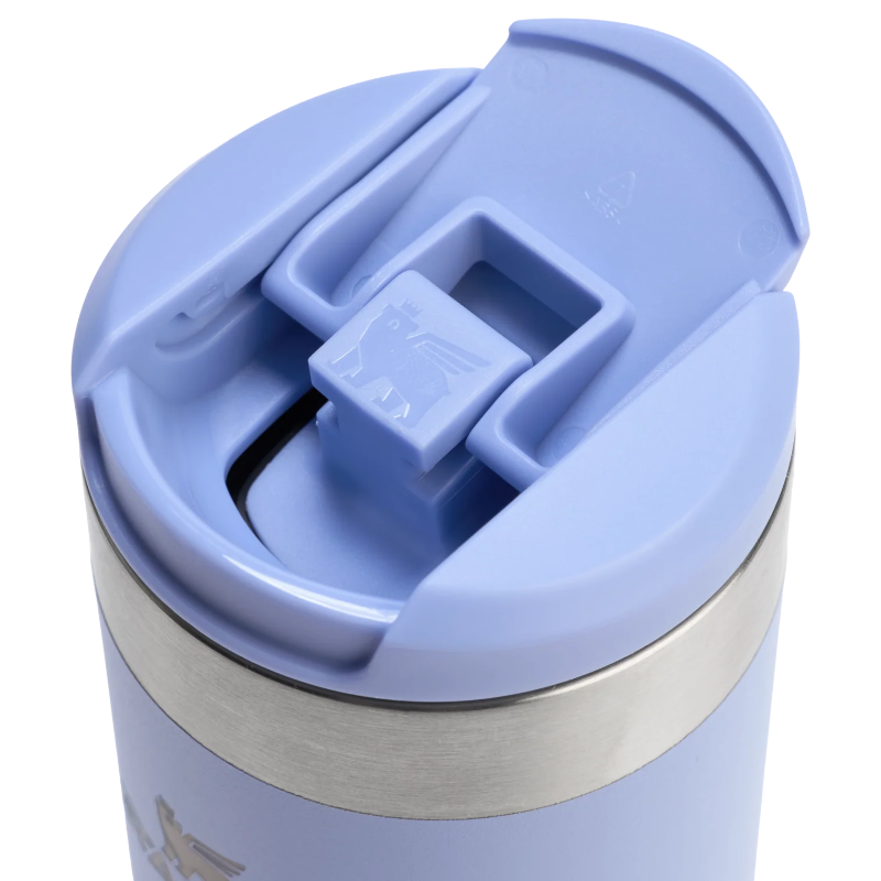 Close-up of a light blue travel mug with a lid on a white background